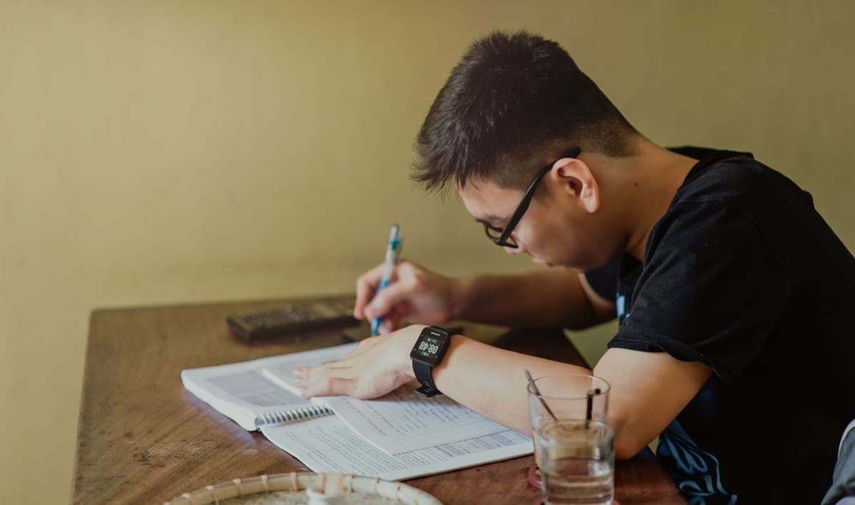 Reading glasses resting on printed documents on a table