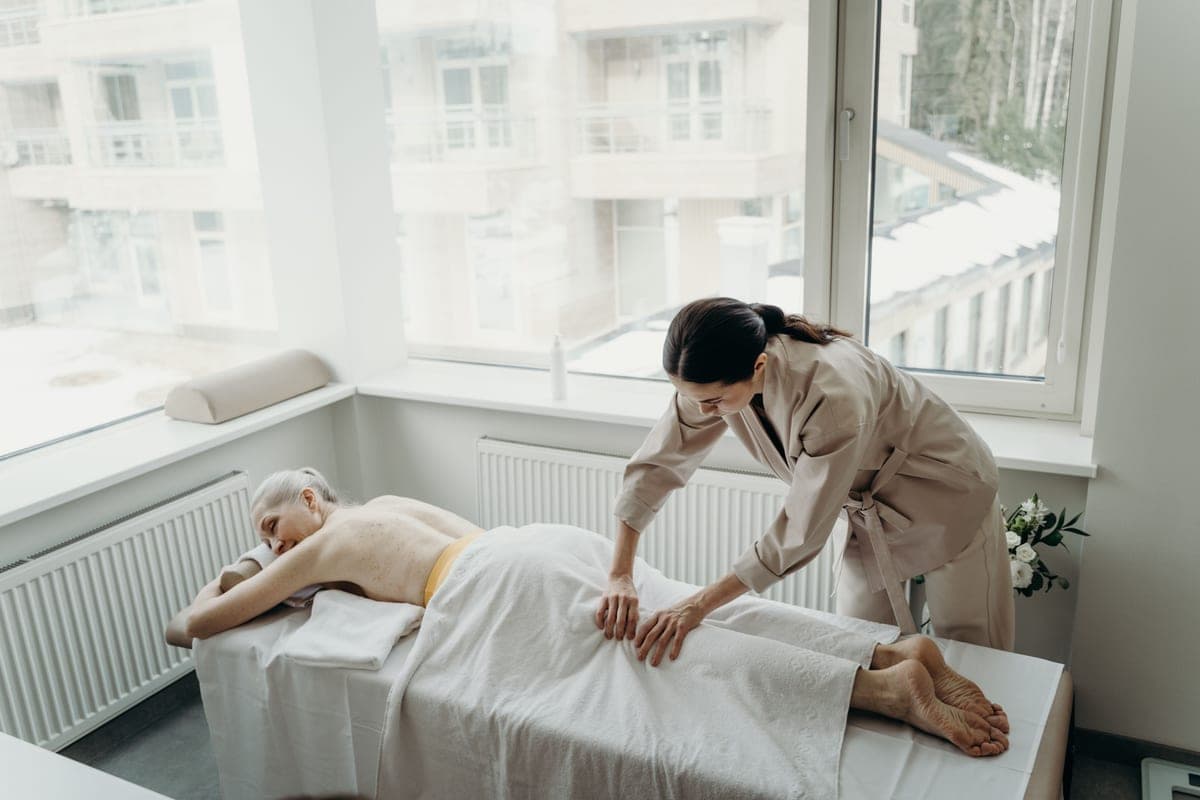 An older woman working through exercises with a therapist